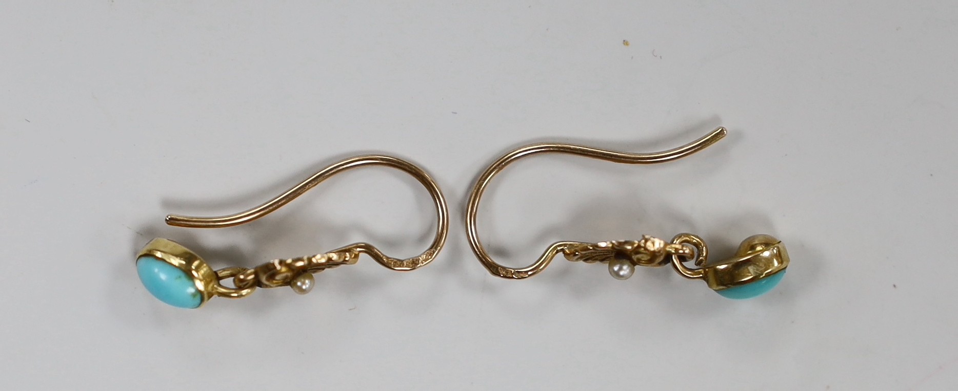 A pair of early 20th century French yellow metal (18ct poincon mark), turquoise and seed pearl set drop earrings, 18mm, gross weight 2.3 grams.